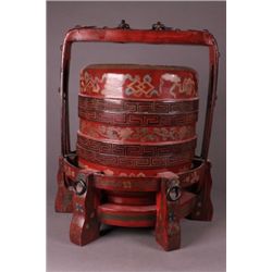 Chinese red lacquer sectional container and stand.