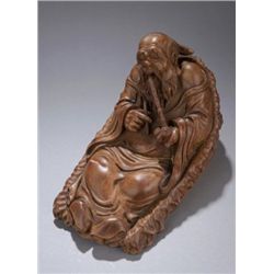 Chinese carved bamboo figure of reclining man.