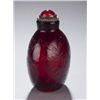 Image 2 : A red glass snuff bottle with incised lotus.