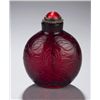 Image 3 : A red glass snuff bottle with incised lotus.