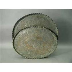 Two large Indian copper trays with ornate embossed all over decoration
