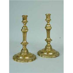 A pair of continental brass candlesticks