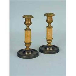 A pair of Regency brass candlesticks