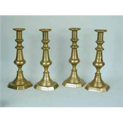 A set of four 19th century brass candlesticks