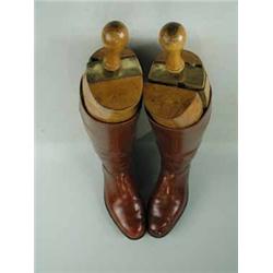 A pair of brown leather polo boots