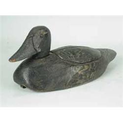 A painted and carved decoy duck with weight