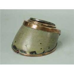 A copper mounted horse hoof ash tray with a lidded compartment