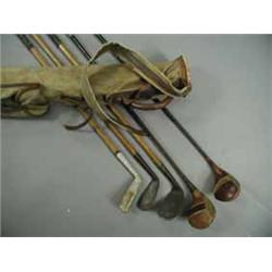 A canvas golf bag and sixteen various clubs Est.40/6