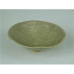 A Northern Sung celadon conical dish with incised decoration