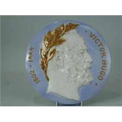 A pottery plaque depicting Vitor Hugo by E. Lachenal