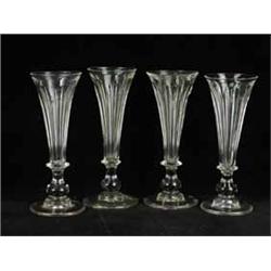 Four 19th century tall glasses with fluted trumpet bowls