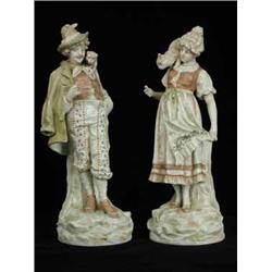 A pair of Ernest Bohne Sohne figures of a gentleman with a monkey and a lady with a cat