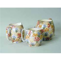 A set of three Grimwade 'Marguerite' chintz graduated jugs