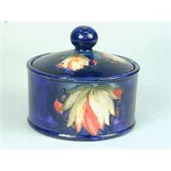 A Moorcroft blue glazed cylindrical box and cover