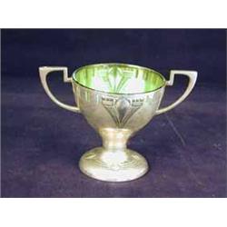 A WMF plated bowl with embossed decoration and a green glass liner
