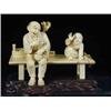 Image 1 : A late l9th/early 20th Century Japanese ivory group of an old man with a pipe seated on a bench