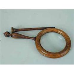 A rosewood library magnifying glass