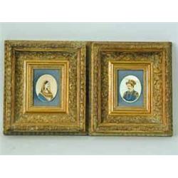 A pair of 19th century Indian oval portraits of a lady and gentleman in traditional dress