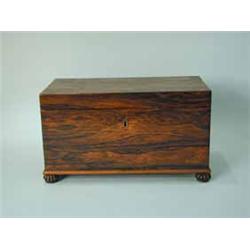 A Regency rosewood teacaddy with two lidded compartments and cast brass ring handles