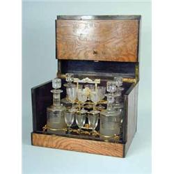 A l9th Century French stained oak cased liqueur set with four decanters