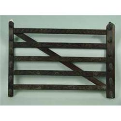 A carved mahogany whip rack