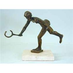 A bronze figure of a tennis player