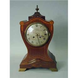 An Edwardian mahogany mantel clock with strung and inlaid decoration