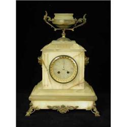 A 19th century French alabaster mantel clock with gilt bronze mounts and a striking drum movement. 4