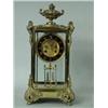 Image 1 : A late 19th century French brass mantel clock having a visible escapement and cast mounts