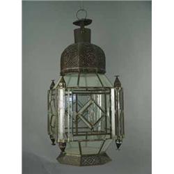 A large Moroccan style iron hanging lantern with pierced decoration and glazed panels