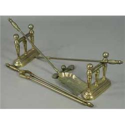 A set of three brass fire irons