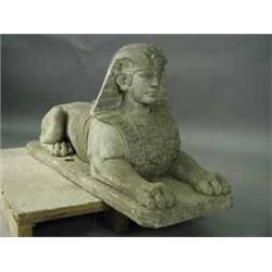 A composition stone sphinx on a rectangular plinth base