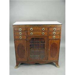 An Edwardian strung mahogany dental cabinet with a ceramic top and drawer linings