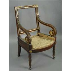 A French Empire library chair with carved and gilt detail