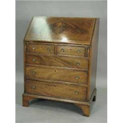 A reproduction mahogany bureau with a stepped interior