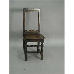 A 17th century oak backstool on turned front legs Est.200/30