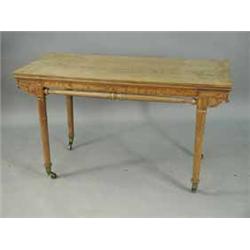 A late 19th century oak (?) centre table with a shallow frieze drawer over two high turned and carve