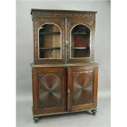 A good l9th Century Anglo-Indian hardwood cabinet with extensive carved decoration to the front