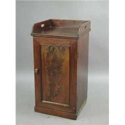 A Victorian mahogany pot cupboard with a tray top and a single panelled door