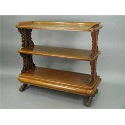 A Victorian oak free standing buffet the three tiers supported on panelled and fret cut ends and car