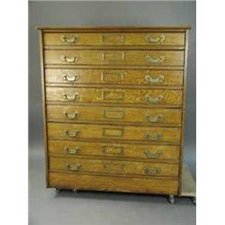 An Edwardian pine plan chest with grained oak decoration