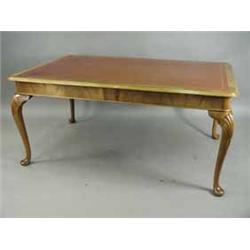 A walnut library table with a leather inset