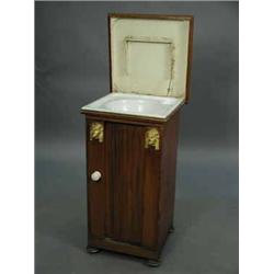 A 19th century French 'tin' washstand with grained decoration and applied Egyptian heads