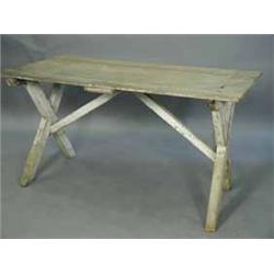 A pine tavern table with a plain plank top and a painted X frame