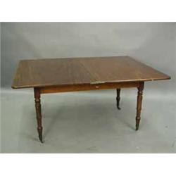 A mid 19th century mahogany dining table with a swivel fold-over top