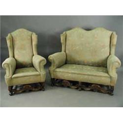 A Queen Anne style three piece suite with serpentine top rails and shaped and carved stretchers