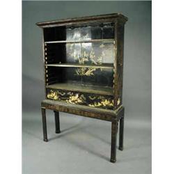 A black lacquered open bookcase raised on a stand