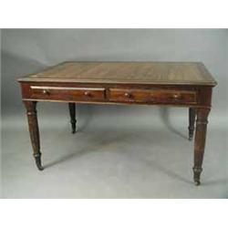 A Victorian mahogany two drawer writing table by Maple and Co.