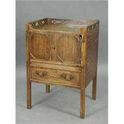 A George III mahogany tray top commode with a pierced gallery
