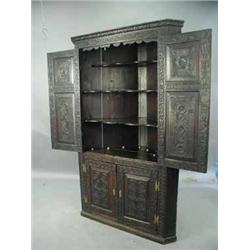 A George III later carved oak corner cupboard